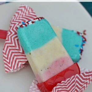 A piece red, white, and blue pudding popsicle on a plate