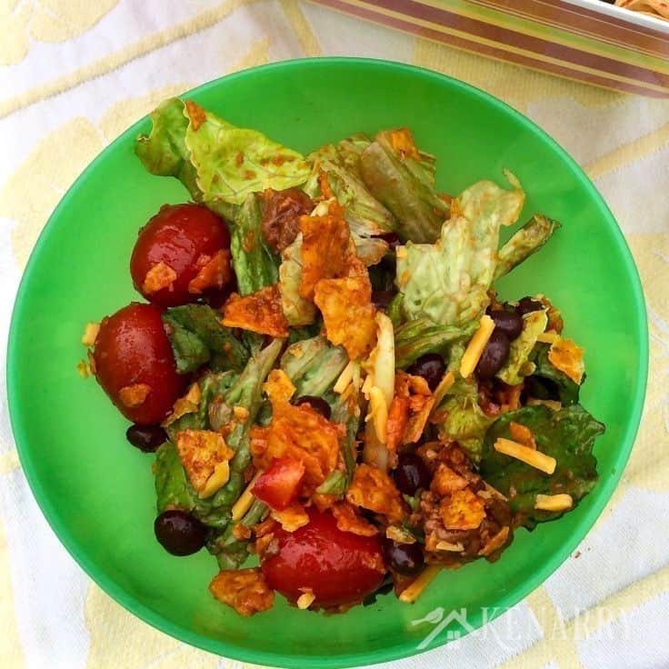 A green bowl filled with taco salad