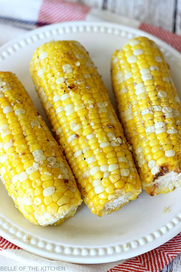 A plate of food, with grilled corn