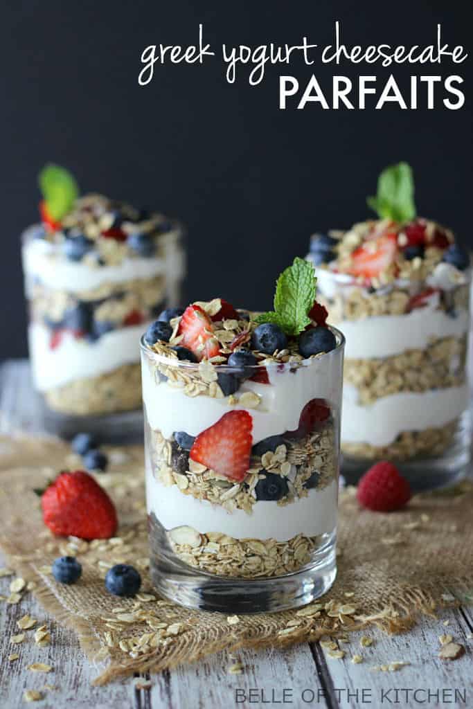 parfaits made of fruit, yogurt and granola, with mint on top inside of glasses