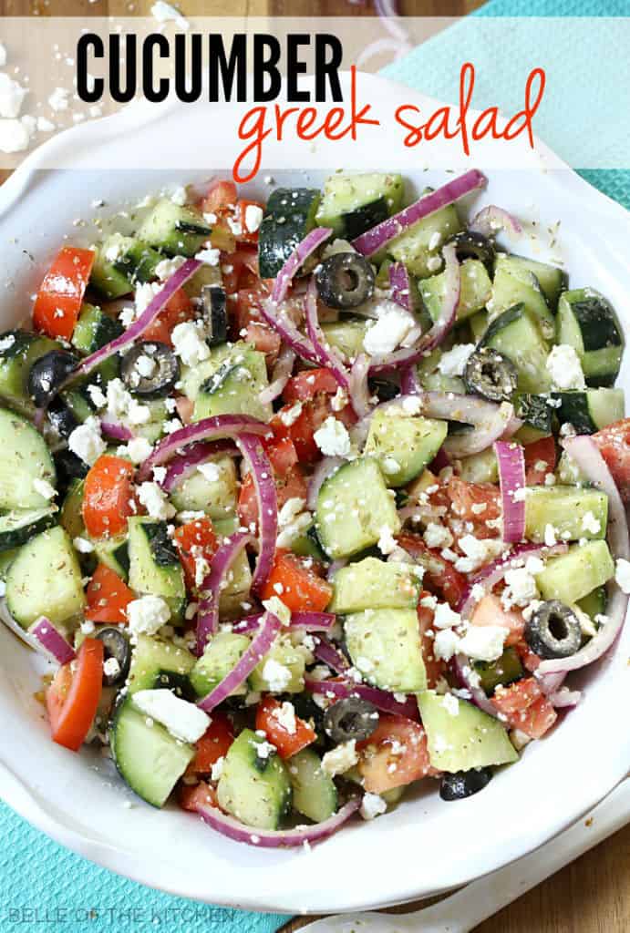 A plate of food, with Cucumbers, tomatoes, and onions