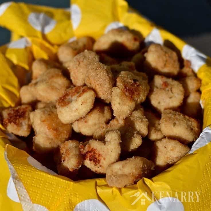 A bowl of chicken nuggets on top of a yellow polka dot napkin