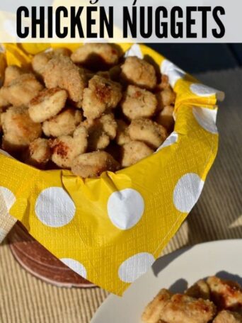 A bowl of chicken nuggets on top of a yellow polka dot napkin