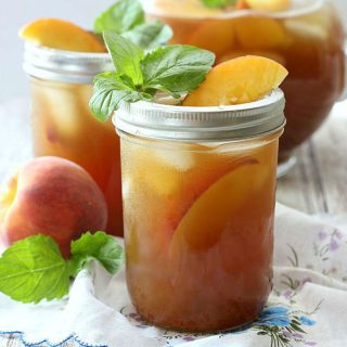 This Peach Sweet Tea combines two delicious southern flavors all in one glass! Fresh brewed tea is sweetened with simple syrup and pureed peaches, then served over ice for a cool, refreshing treat!