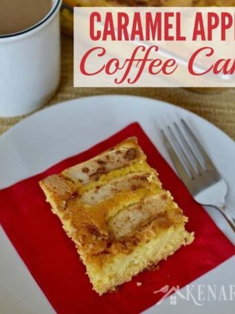 A piece of apple cake on a plate with a fork and red napkin