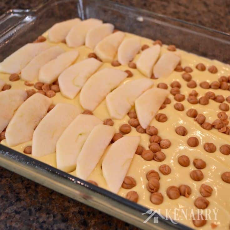 a baking dish filled with cake batter and sliced apples