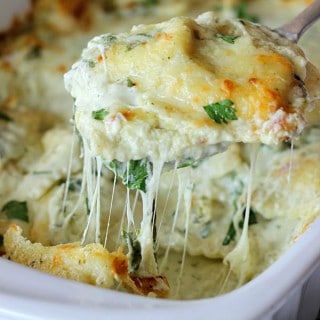 This Artichoke and Spinach Ravioli Bake is made with a creamy and delicious sauce, fresh spinach, mozzarella, and cheesy ravioli. An easy, delicious meal!
