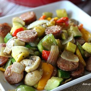 A plate of food, with Sausage and vegetables