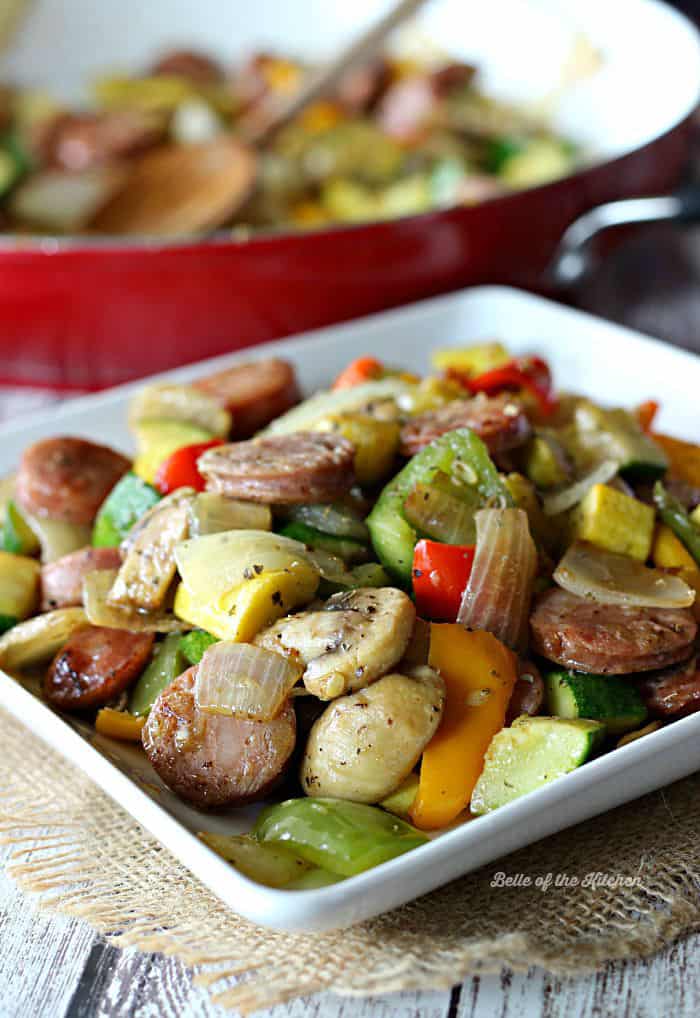 A plate filled with sausage and vegetables