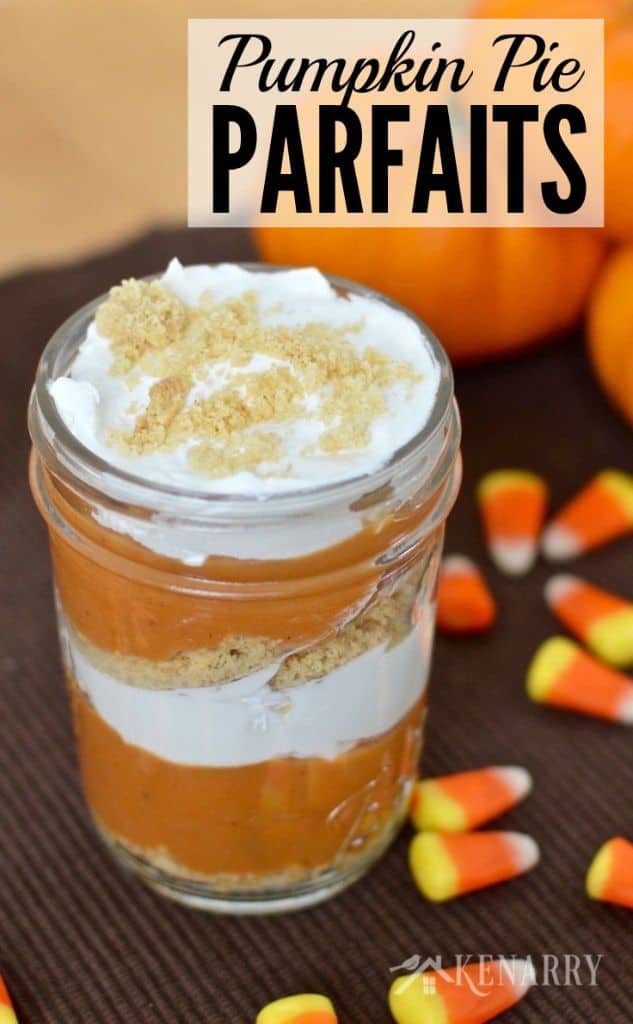 jars with layers of pumpkin, cream cheese, and graham cracker crumbs with mini pumpkins in the background
