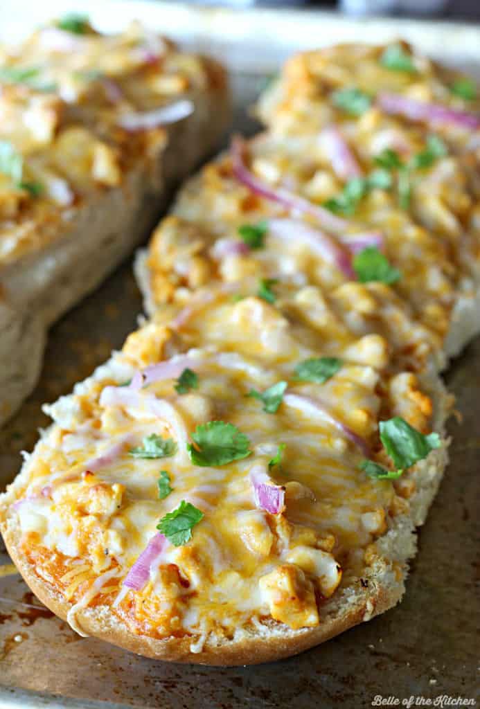 French bread pizza with cheese, red onions, and cilantro on top