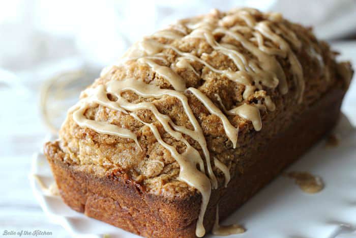 A close up of a loaf of pumpkin bread on a white plate
