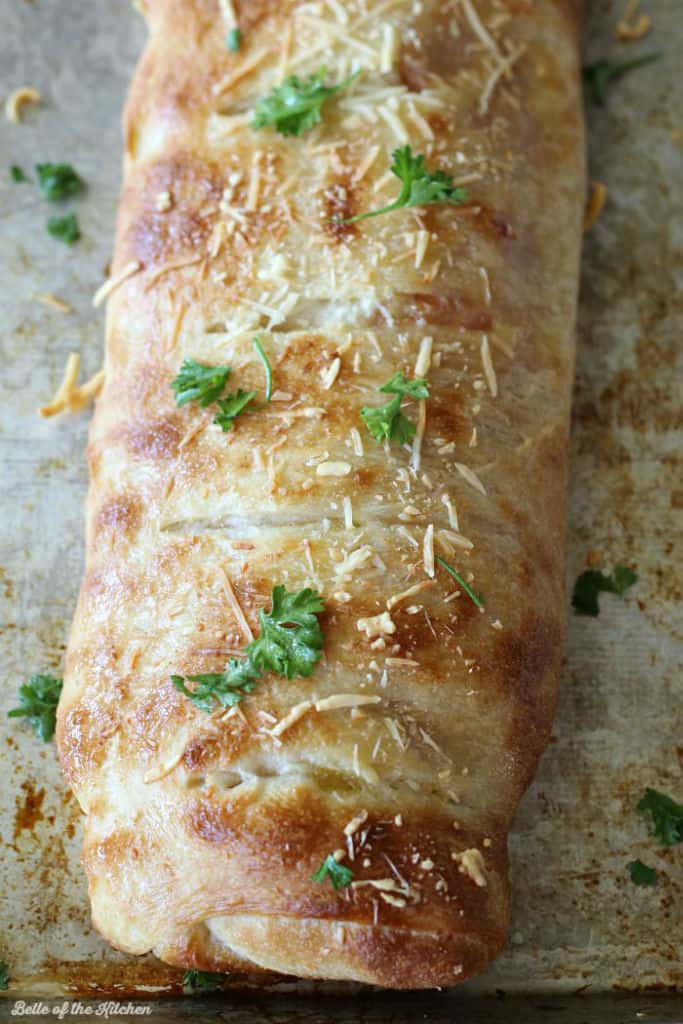 A close up of baked ham and cheese Stromboli
