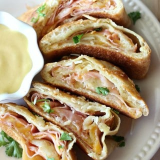 This Ham and Cheese Stromboli is SO GOOD! Pizza crust is stuffed with honey mustard, monterrey jack cheese, and smoky Black Forest Ham, then baked to a crispy and cheesy perfection!