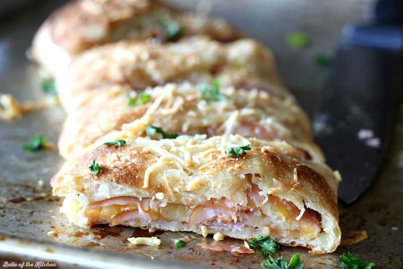 A close up of sliced ham and cheese Stromboli 