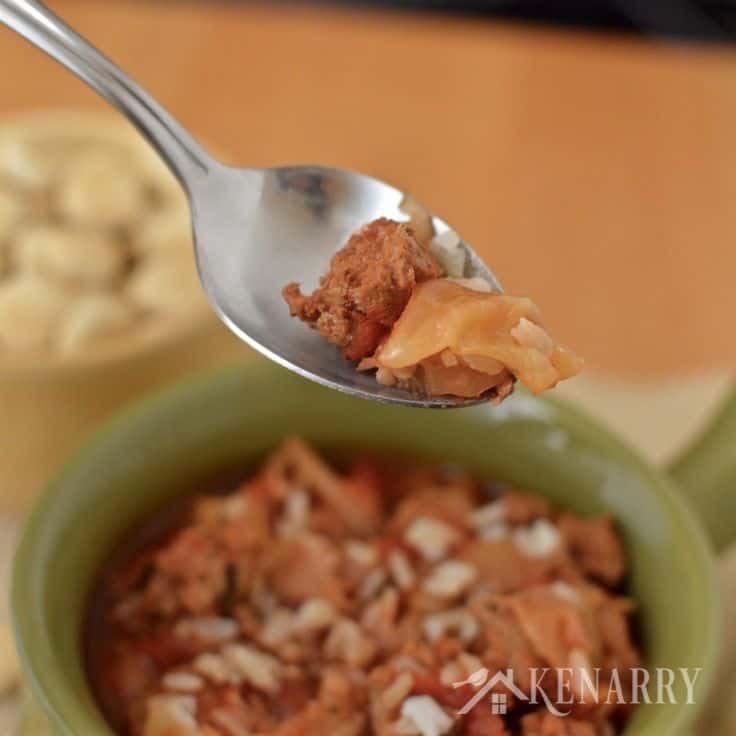 a spoon filled with cabbage soup