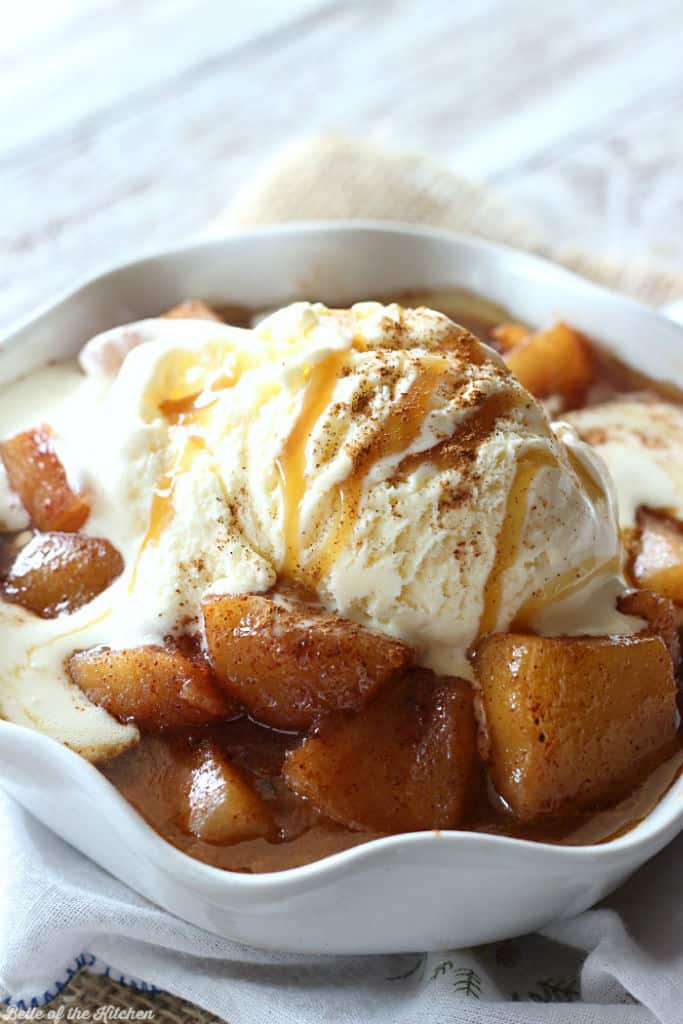 A bowl of baked apples and ice cream