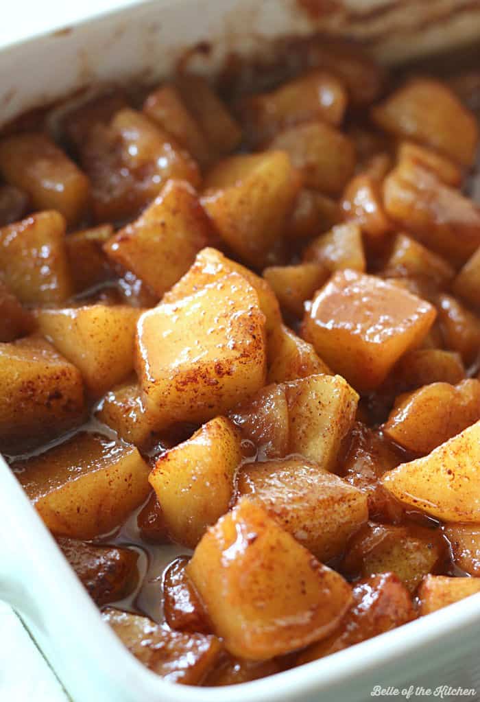 A close up of a bowl of baked apples 