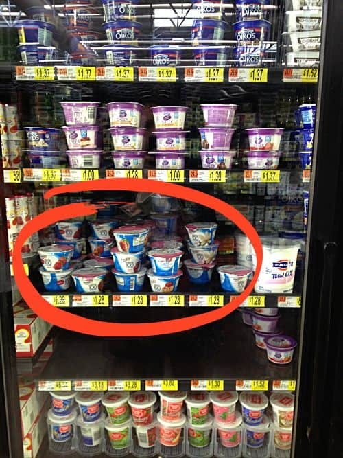 a store shelf with yogurt