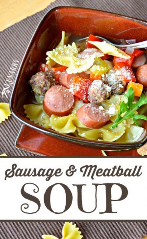 A bowl of food, with sausage, meatballs, and pasta
