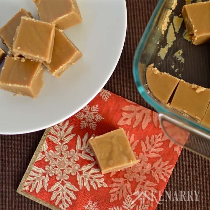 A plate of peanut butter fudge with a slice on a napkin