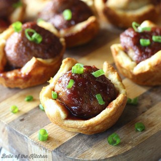 Meatballs topped with a tangy sauce and baked inside a flaky crescent crust. This quick and easy appetizer is sure to please this holiday season!