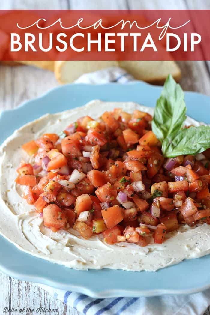 A plate of cream cheese topped with bruschetta and basil