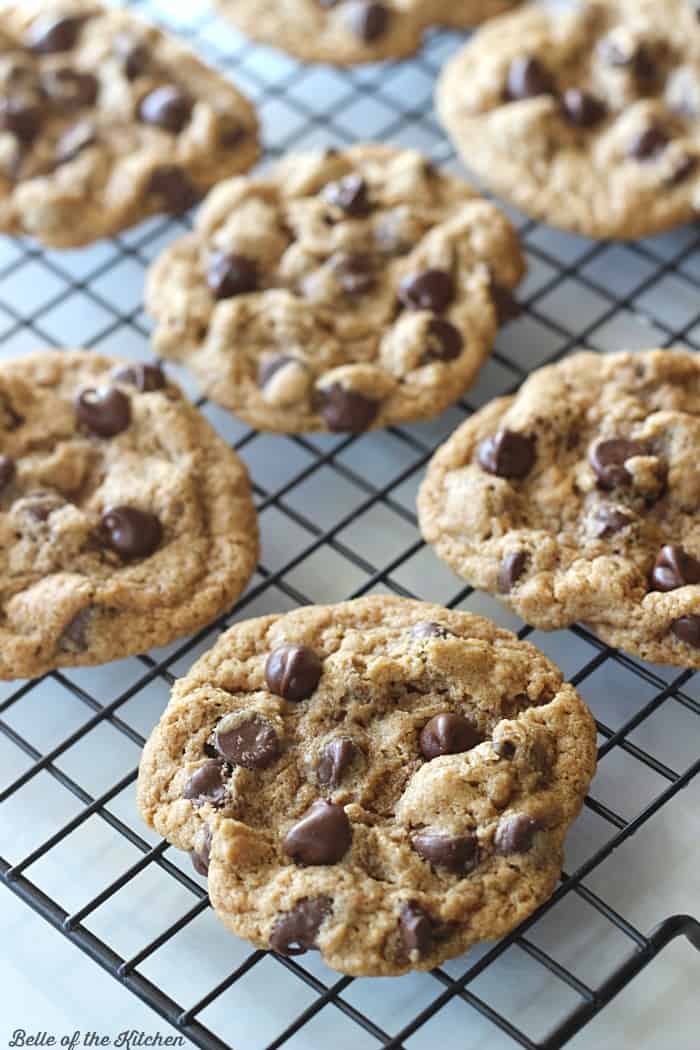 A close up of chocolate chip cookies on a cooling rack