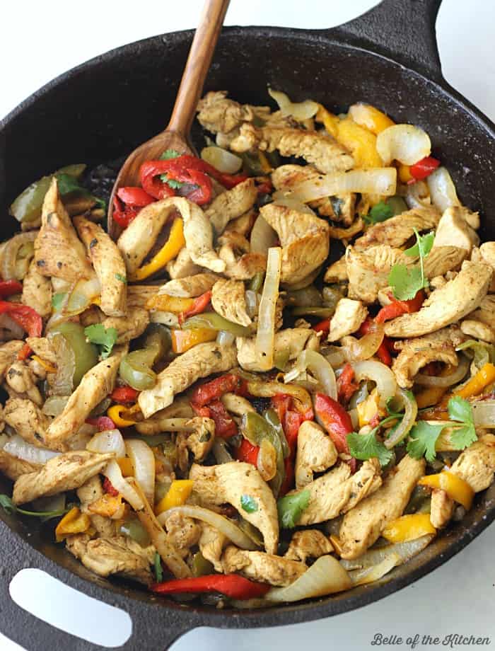 A pan filled with food chicken fajitas