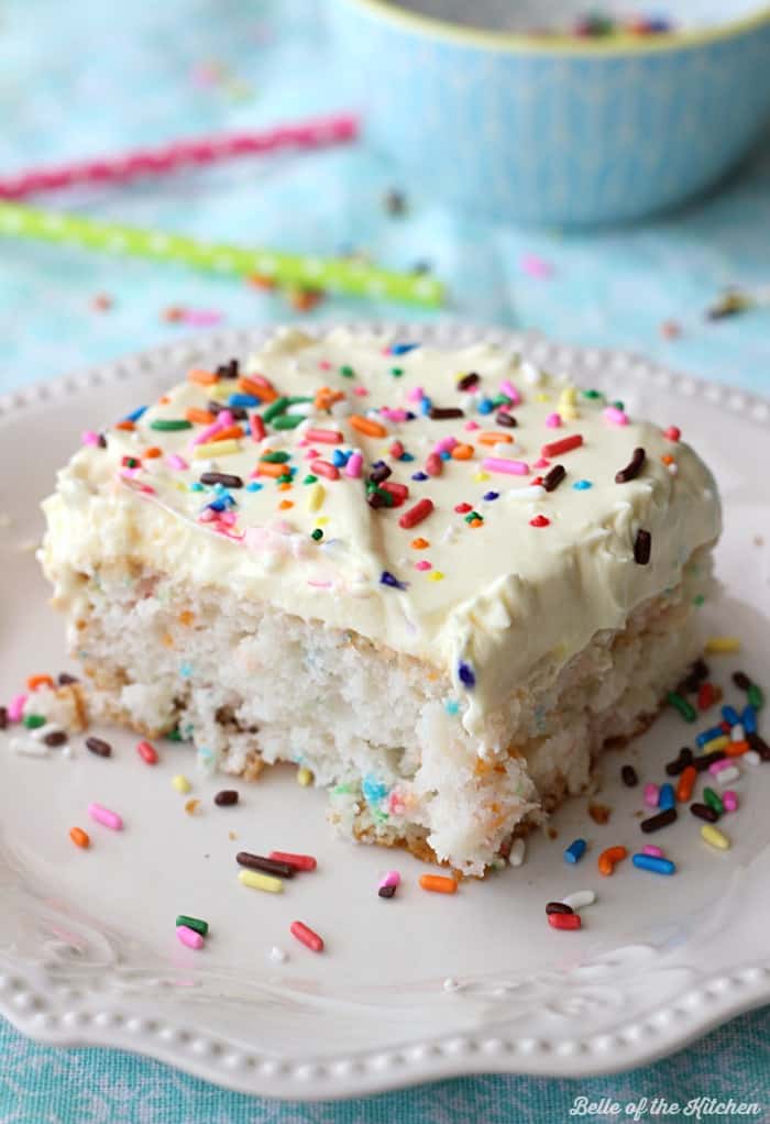 A close up of a piece of cake with sprinkles on top