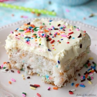 This Skinny Funfetti Cake is made with a cake mix and Greek yogurt, then topped with a light and fluffy whipped frosting! Each serving is less than 200 calories!
