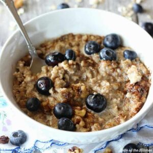 A bowl of oatmeal filled with blueberries