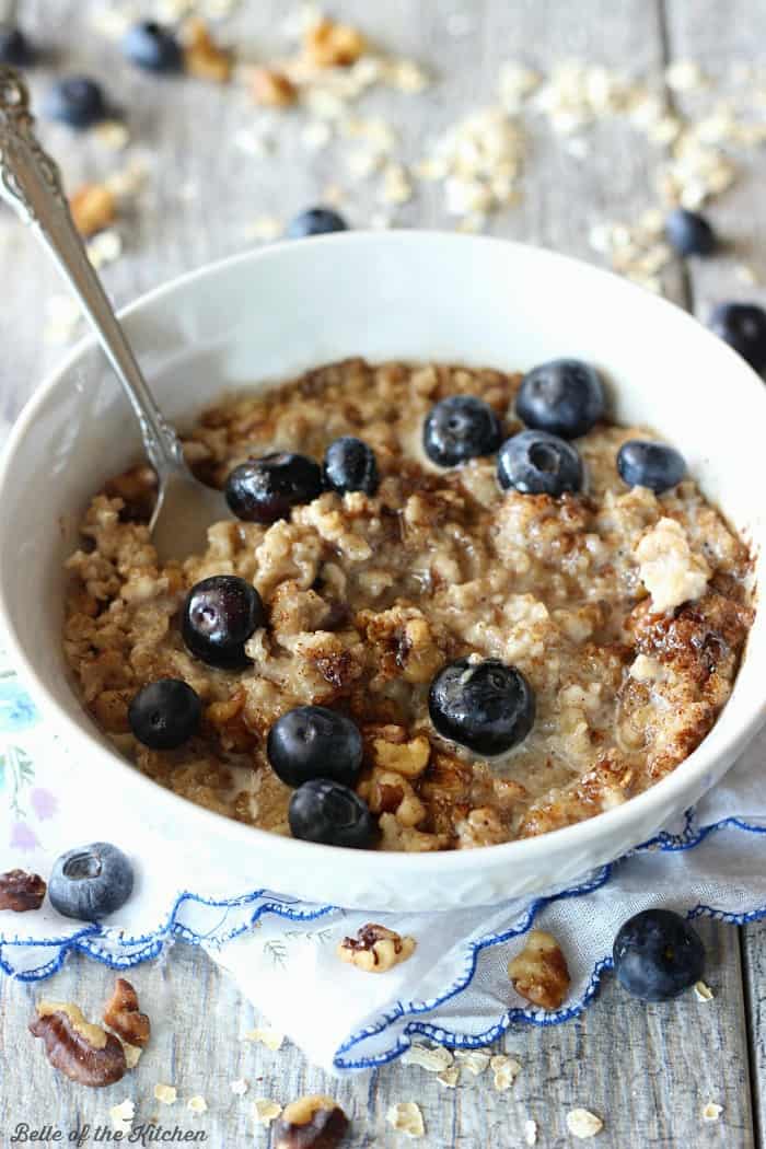 A bowl of oatmeal filled with blueberries