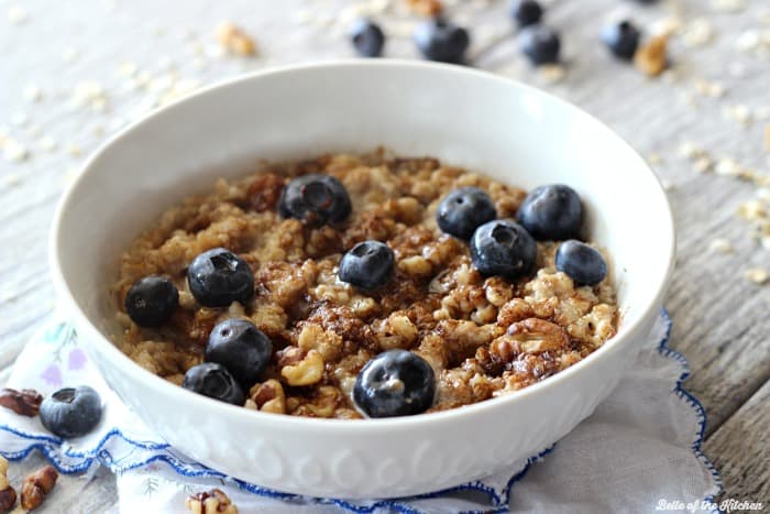 A bowl of oatmeal filled with blueberries