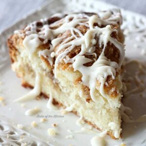 A close up of a slice of coffee cake with vanilla drizzle