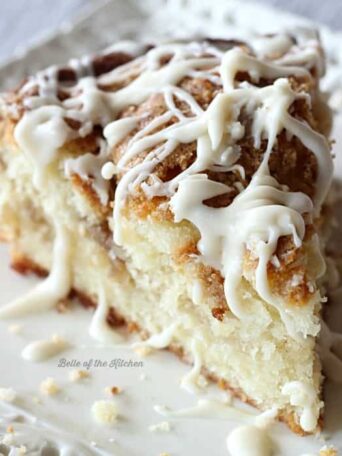 A close up of a slice of coffee cake with vanilla drizzle