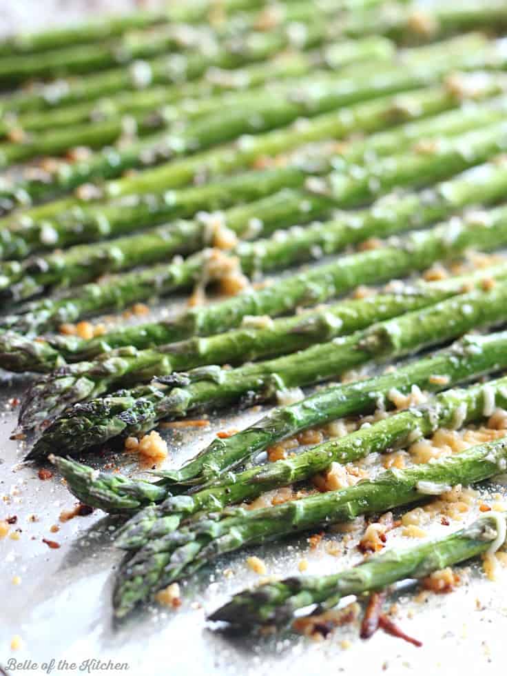 asparagus laid out on a sheet pan with garlic