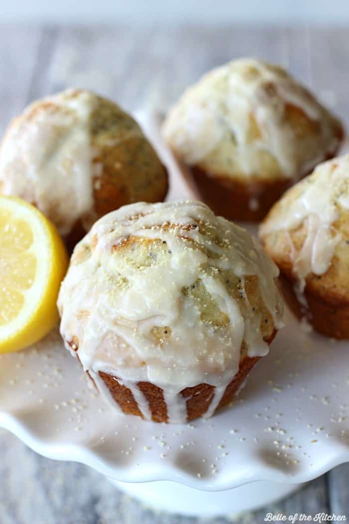 lemon muffins drizzled in vanilla glaze on a plate