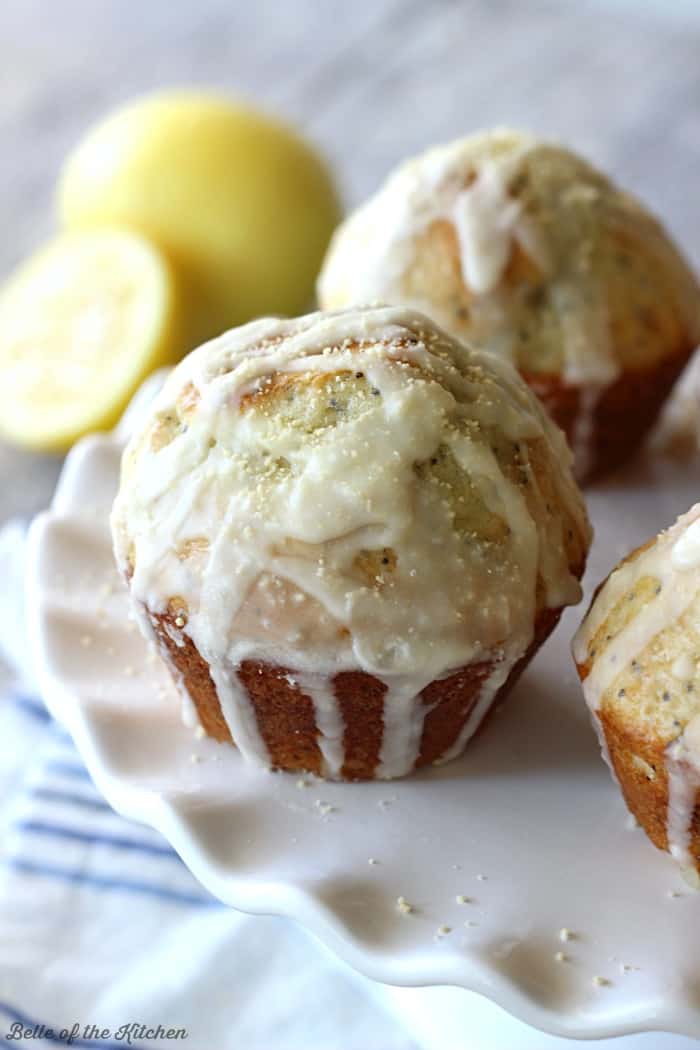 lemon muffins drizzled in vanilla glaze on a plate
