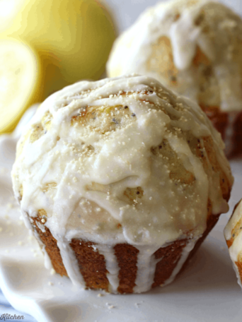 lemon muffins drizzled in vanilla glaze on a plate