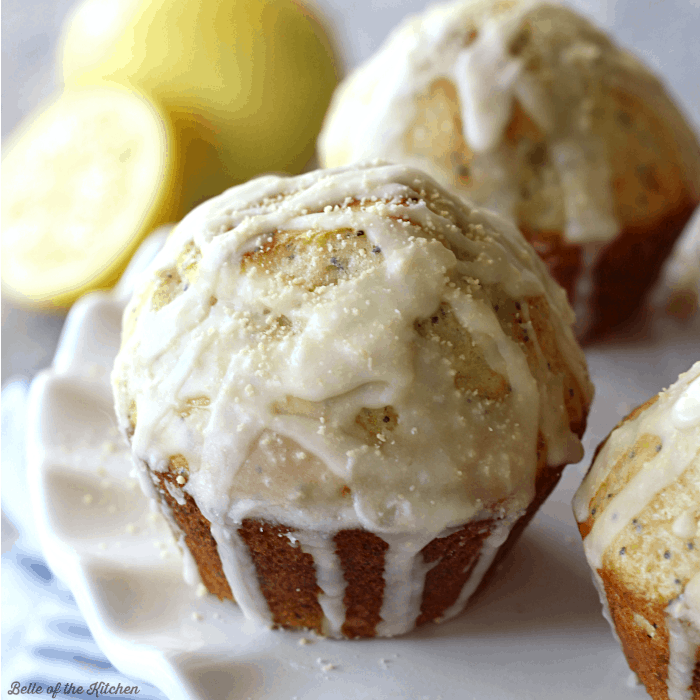 lemon muffins drizzled in vanilla glaze on a plate