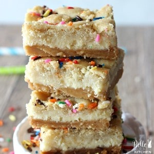 These Sugar Cookie Cheesecake Bars are the ultimate dessert! A layer of sugar cookies followed by a cheesecake filling, all on top of a irresistible Golden Oreo crust. You will LOVE these!