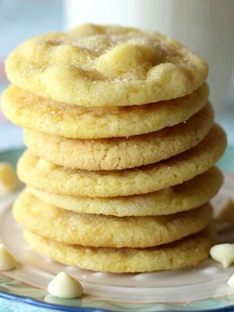 A close up of a stack of lemon cookies with white chocolate chips