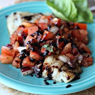Get a healthy dinner on the table in a flash with this Bruschetta Tilapia! The tilapia is oven roasted then topped with bruschetta and a balsamic glaze!