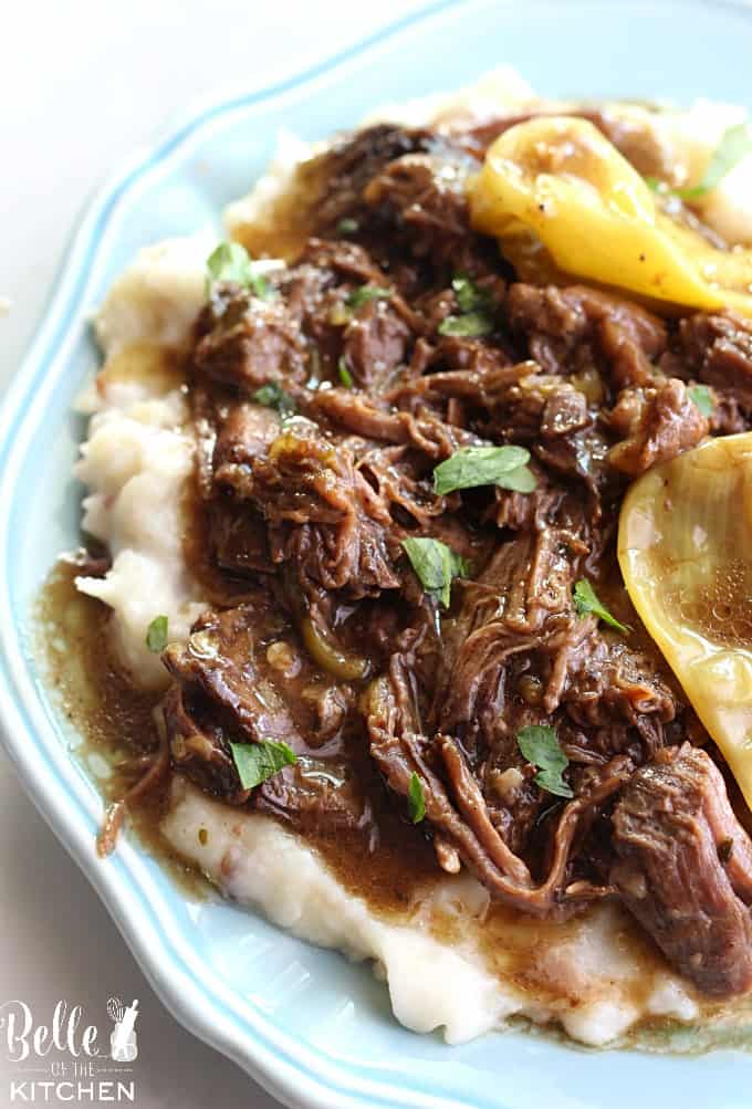 A plate of food Mississippi pot roast on top of mashed potatoes