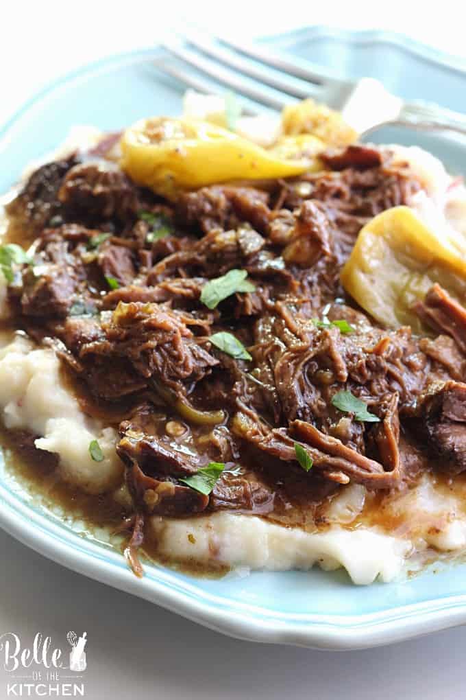 A plate of Mississippi pot roast on top of mashed potatoes