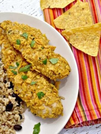 A plate of chicken tenders with rice and beans