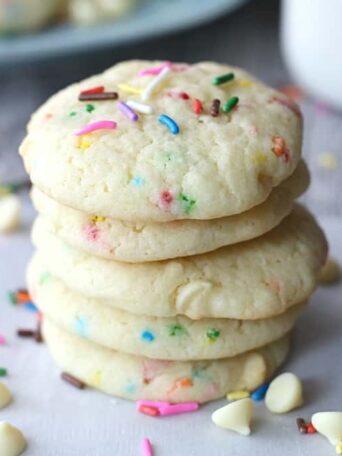 a stack of cookies with sprinkles and white chocolate chips