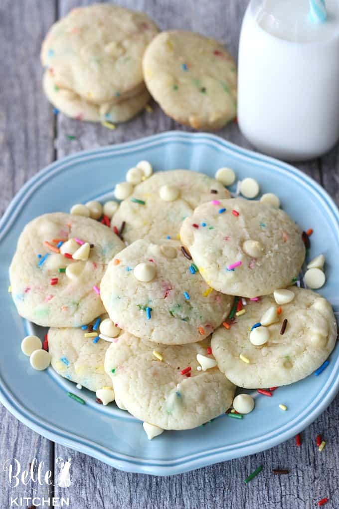 a plate of cookies with sprinkles and white chocolate chips