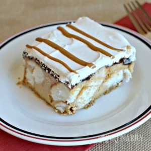 A piece of cake on a plate, with Fudge and Peanut butter